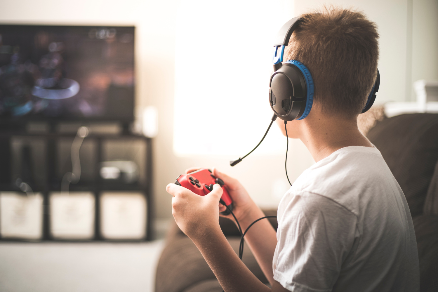 Back of a boy's head playing a video game