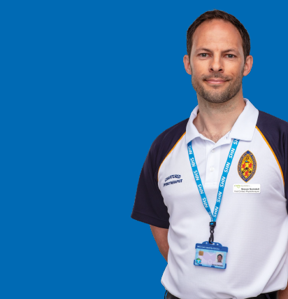 Person in a white polo T Shirt uniform with an NHS lanyard and badge depicting a Physiotherapist